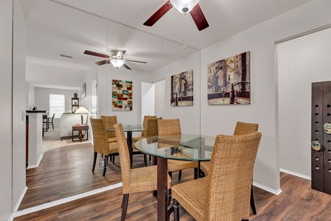A dining room with a glass table and chairs.