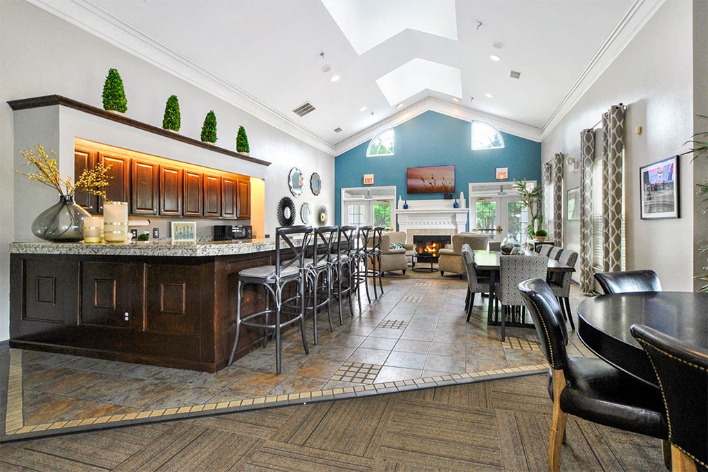 a living room with a bar and a dining room