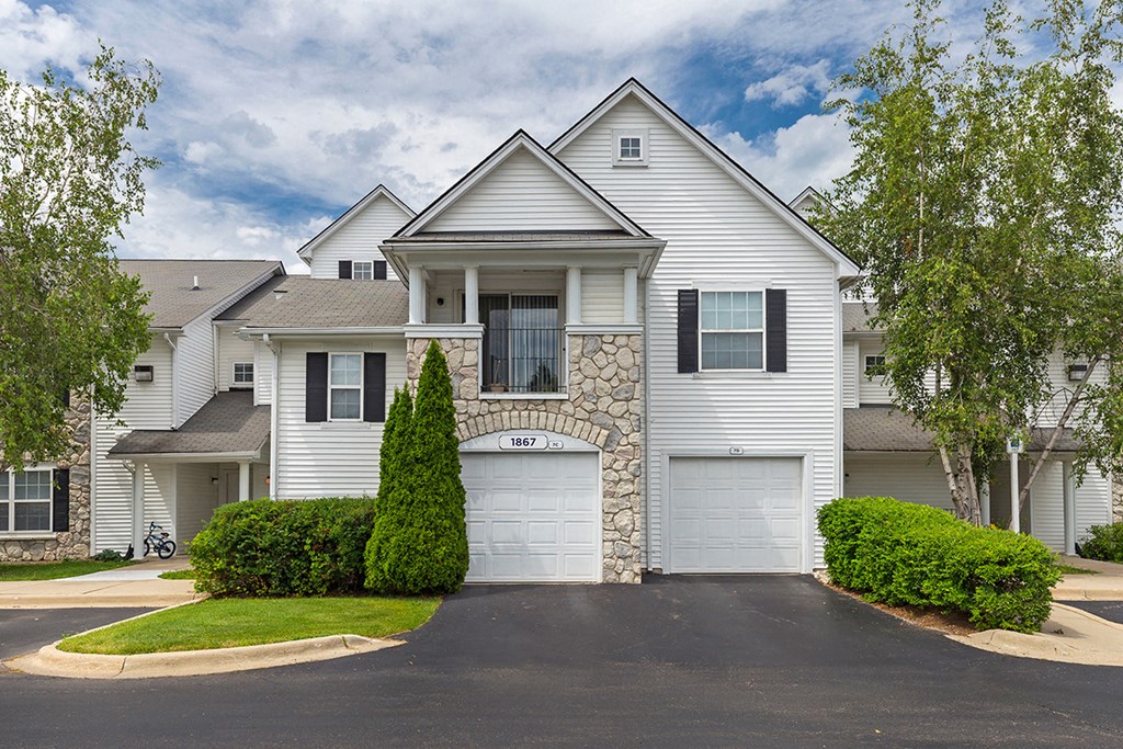a white house with two garage doors