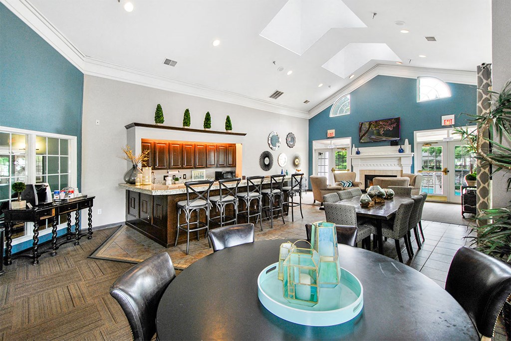 a living room with a table and chairs and a kitchen
