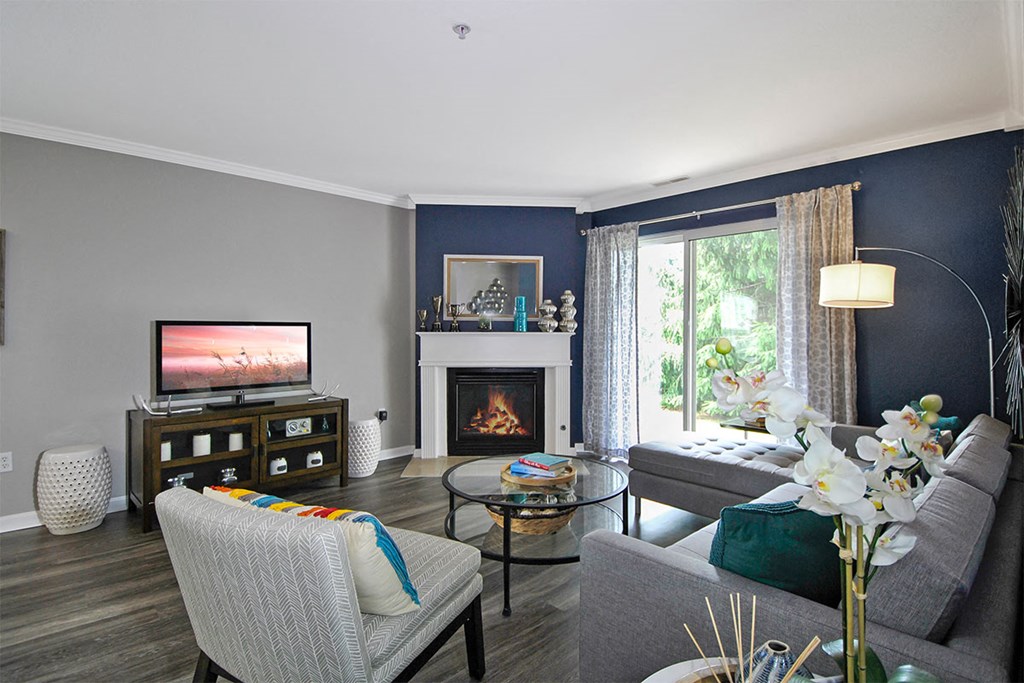 a living room with blue walls and a fireplace