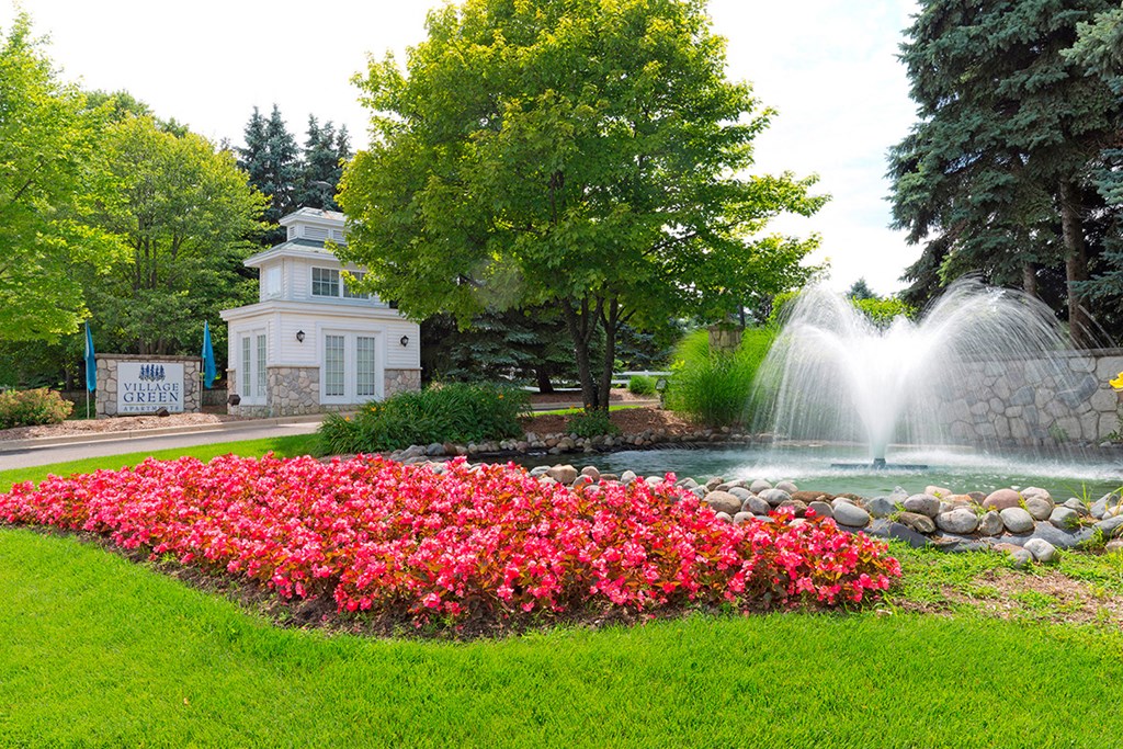 a garden with flowers and a fountain