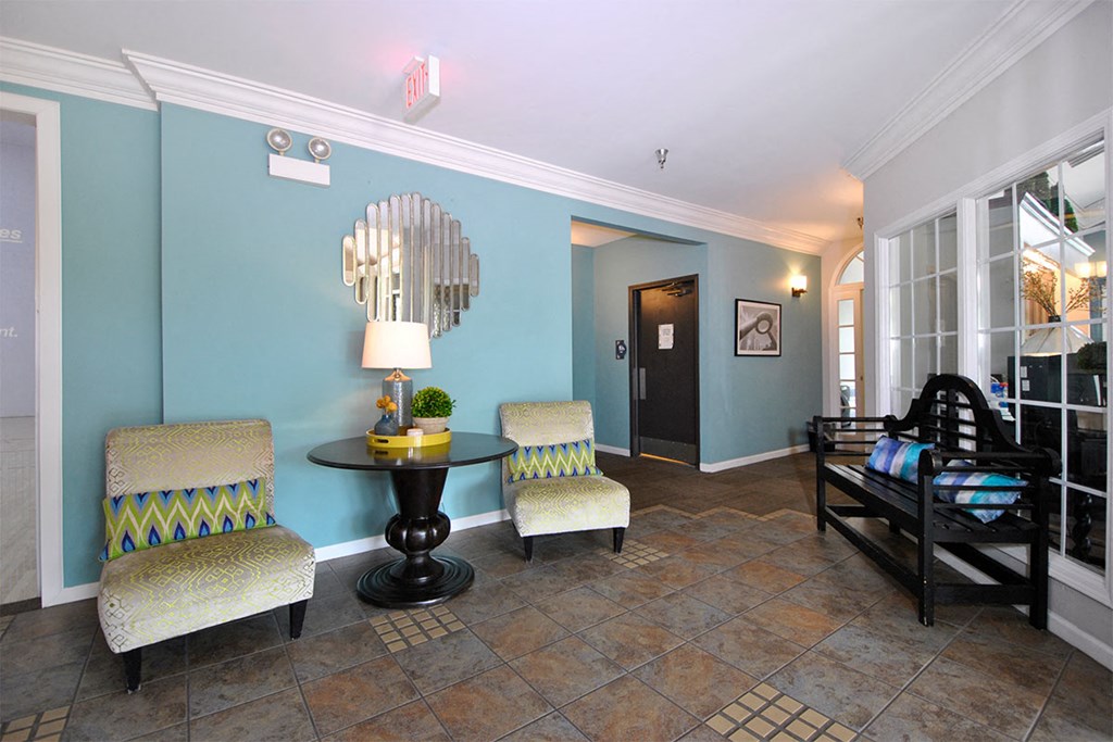 a living room with two chairs and a table