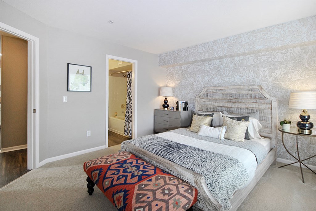 a bedroom with a bed and a dresser