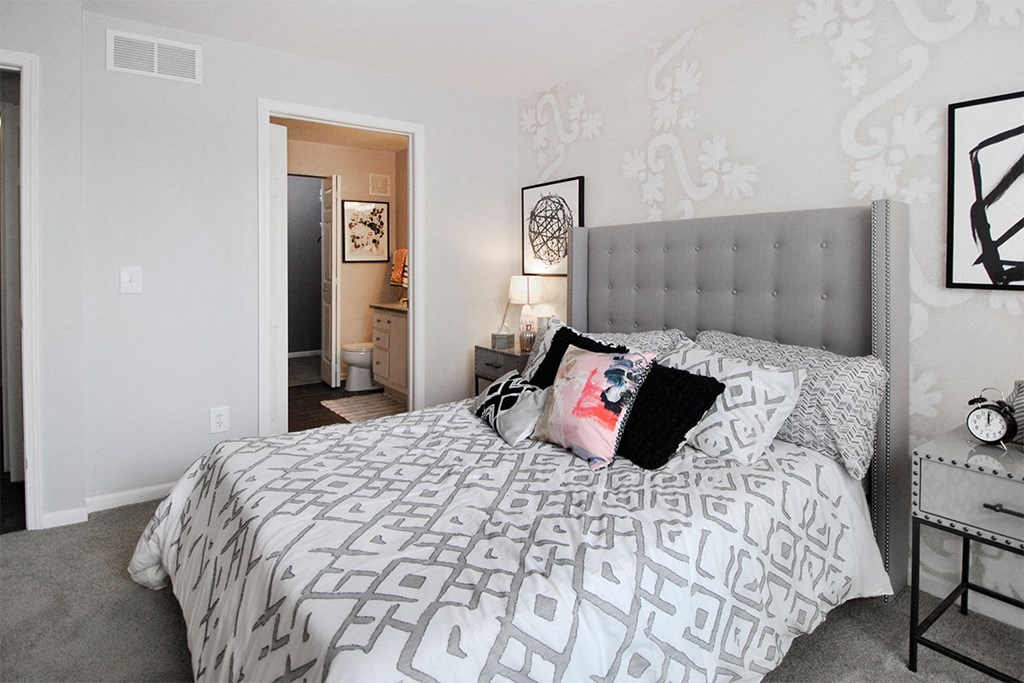 a bedroom with white walls and a bed with pillows