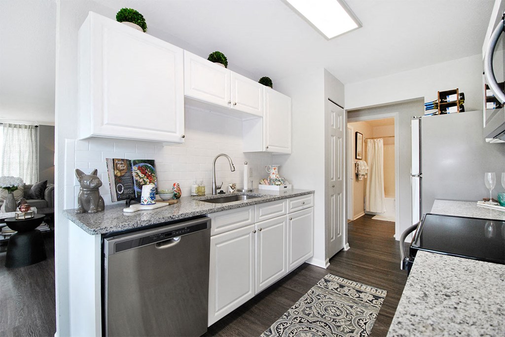 a kitchen with white cabinets and stainless steel appliances