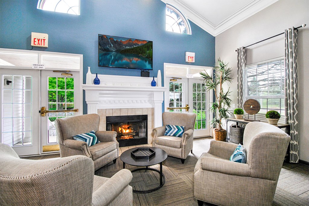 a living room with couches and chairs and a fireplace