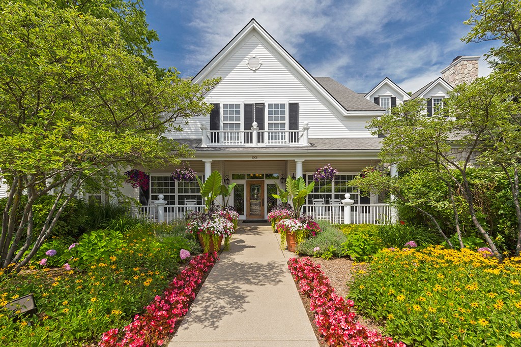 the front of a house with a garden and a walkway