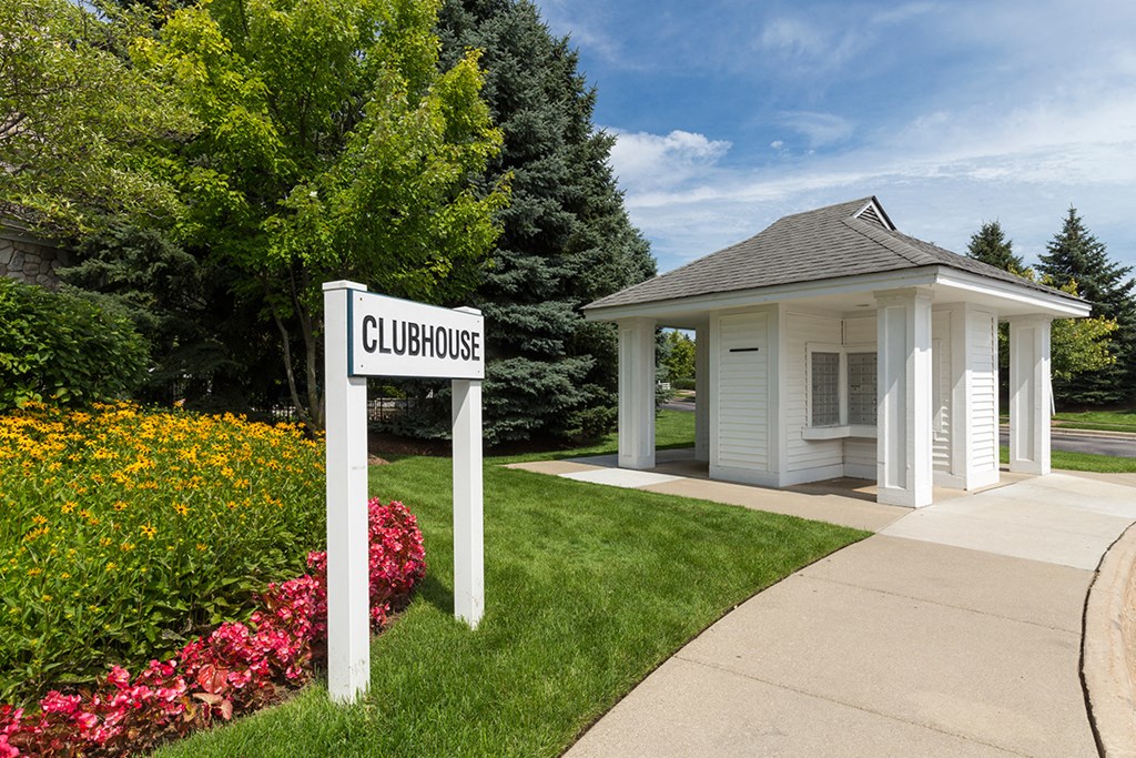 a sign in front of a white building with a gazebo