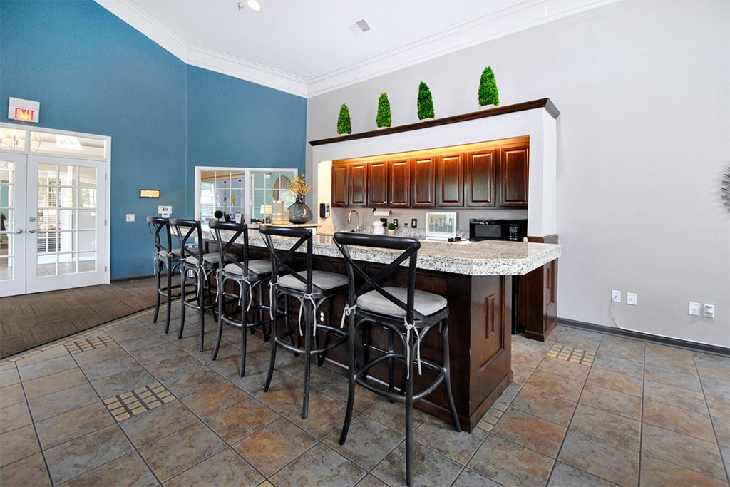 a kitchen with a bar and stools in a house