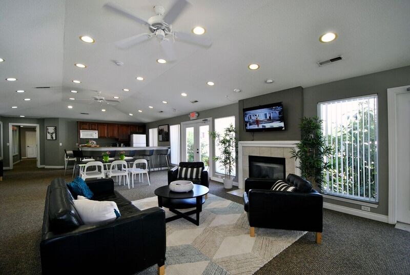 A living room with a fireplace and a television.