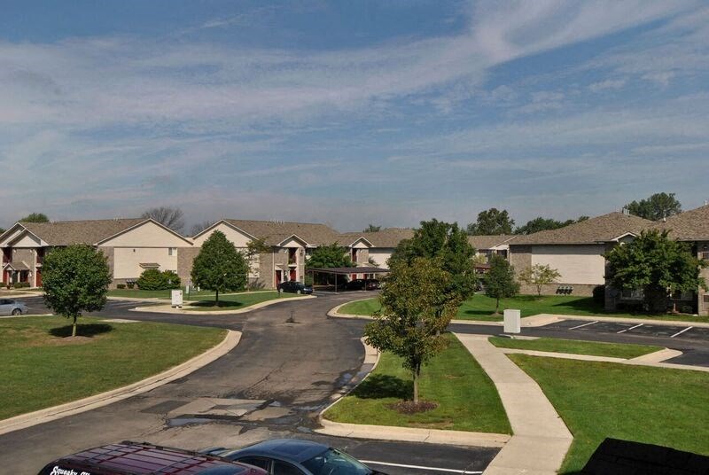A residential area with houses and cars.