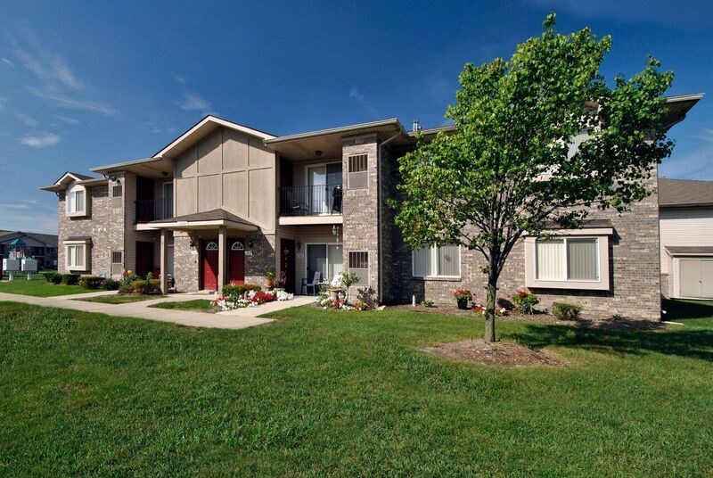 A large house with a tree in front of it.
