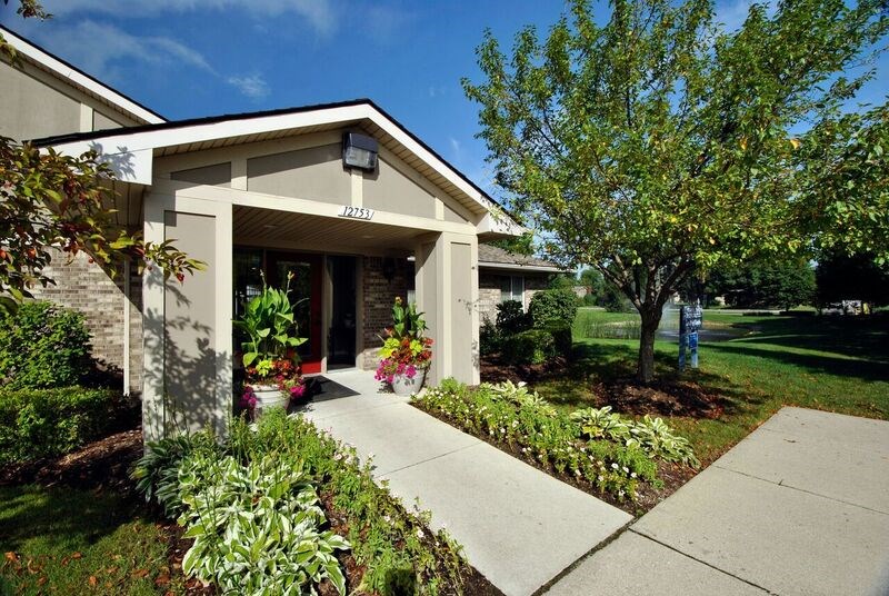 A house with a front yard and a tree.