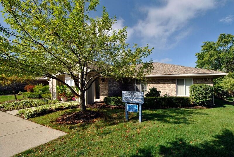 A blue sign in front of a house.