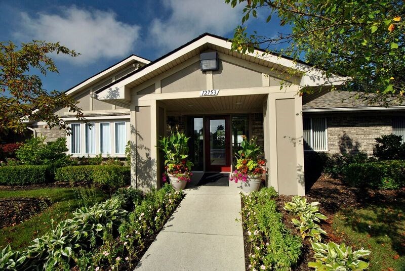 A house with a front yard and a walkway leading to the front door.