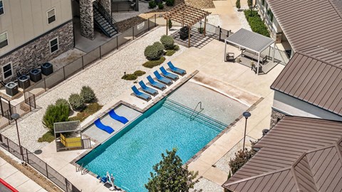 A pool with a slide and a hot tub.