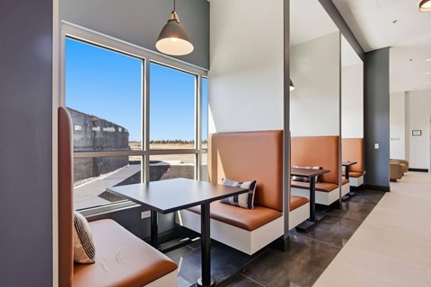 A modern dining area with a table and chairs.