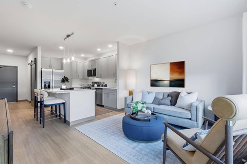 A modern kitchen with a dining table and a couch.