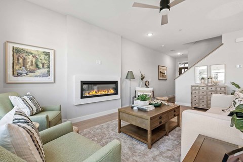 A living room with a fireplace and a painting on the wall.