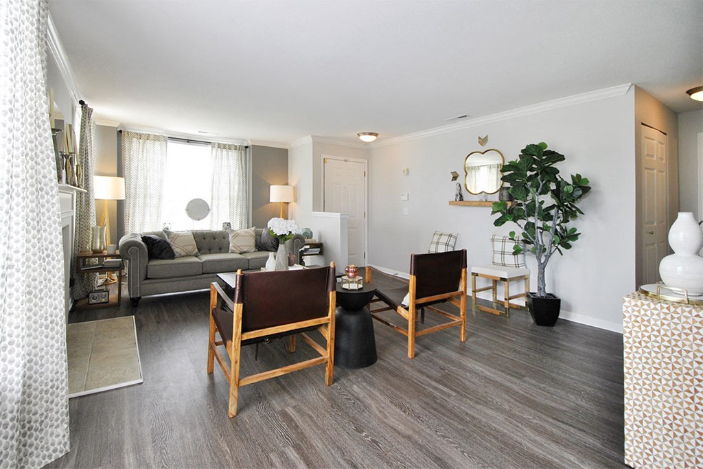 a living room with a couch and a table with chairs