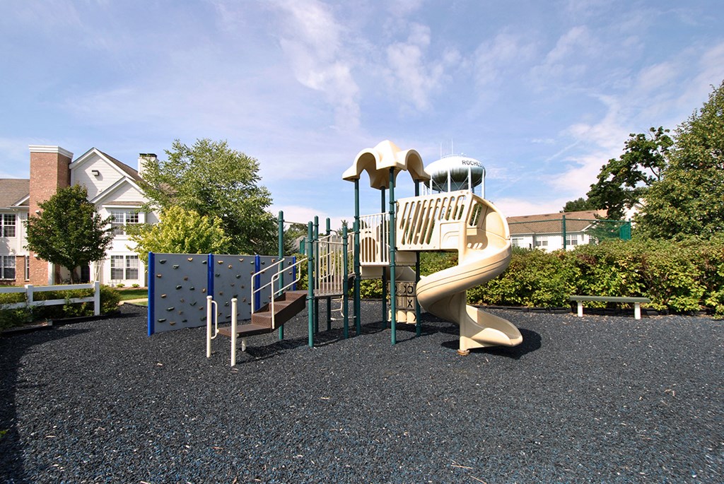 a playground with a slide in a park