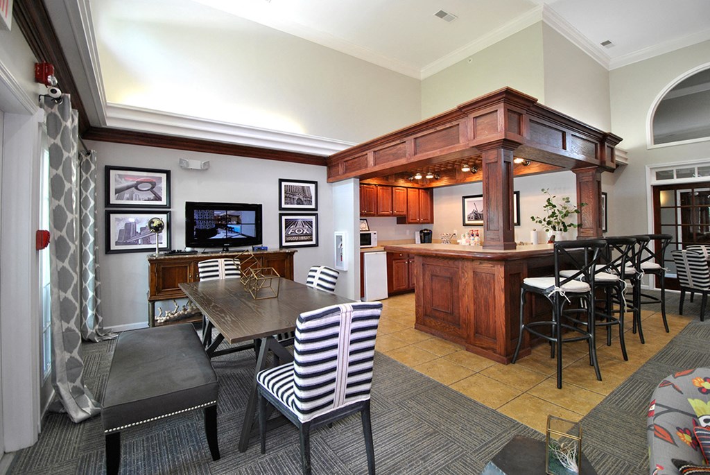 a dining room and kitchen with a bar and a table