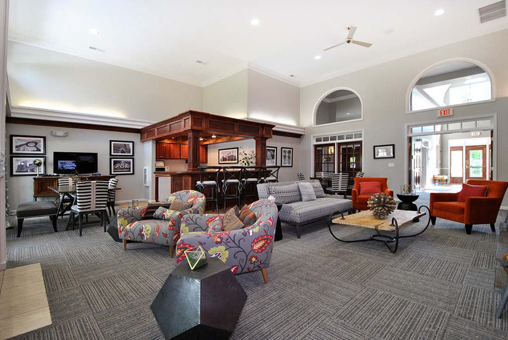 a large living room with furniture and a bar