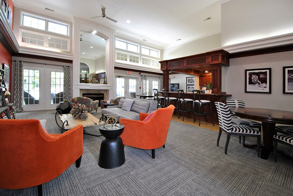 a large living room with furniture and a bar