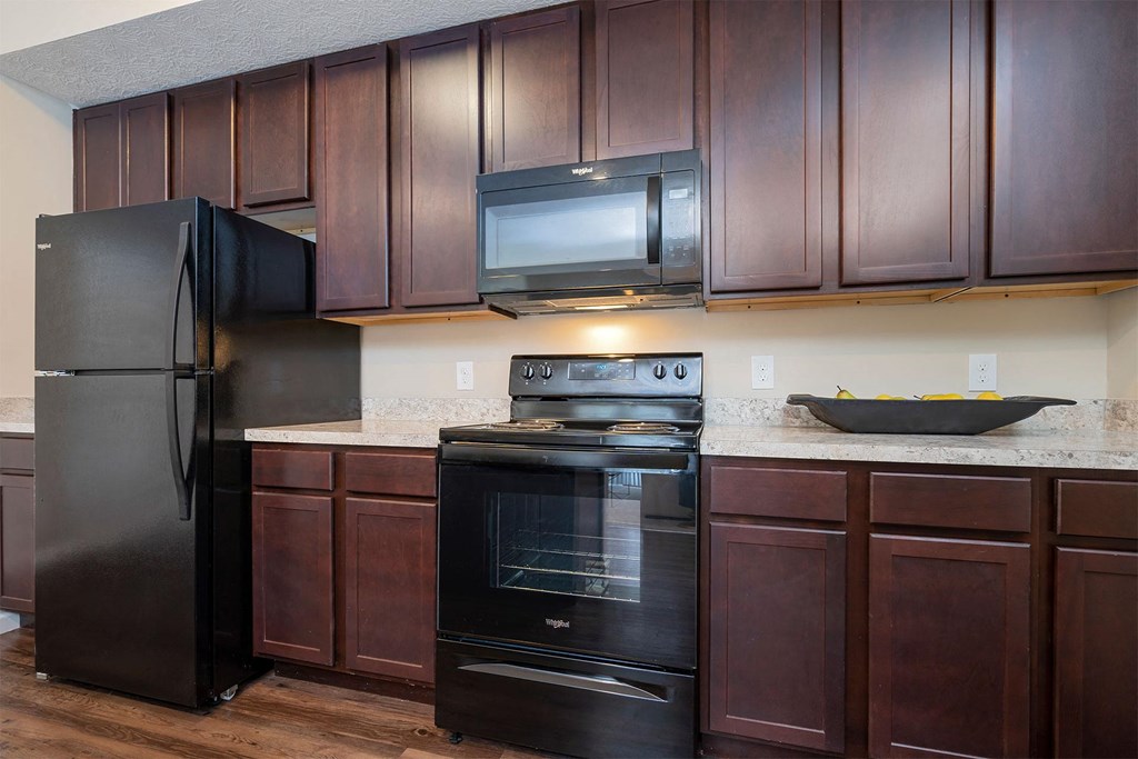 a kitchen with a stove microwave and refrigerator