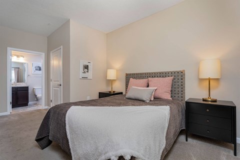 a bedroom with a bed and a door to a bathroom