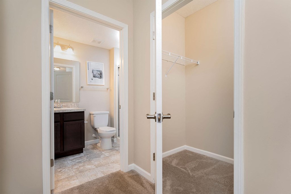 a door opens into a bathroom with a toilet and a sink