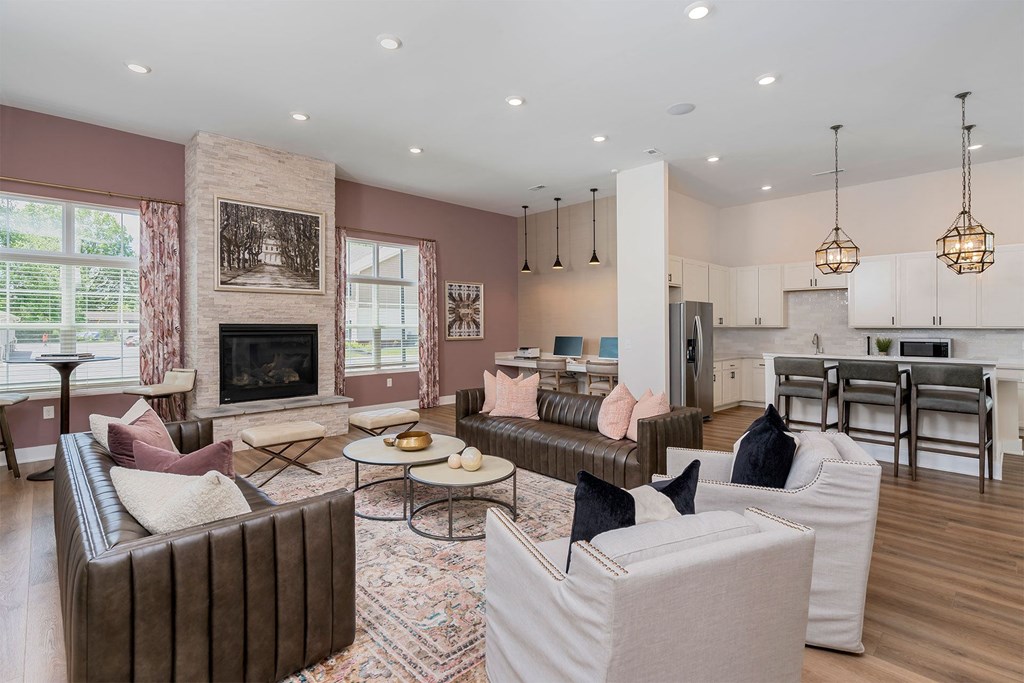 a living room with couches and chairs and a fireplace