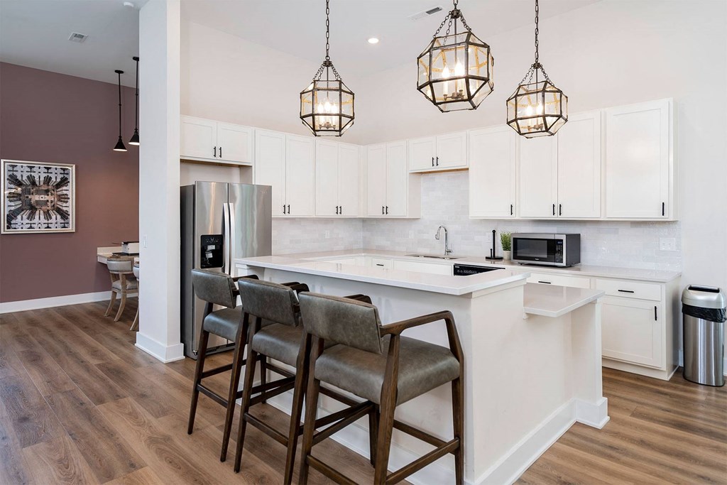 a kitchen with a large island with three stools