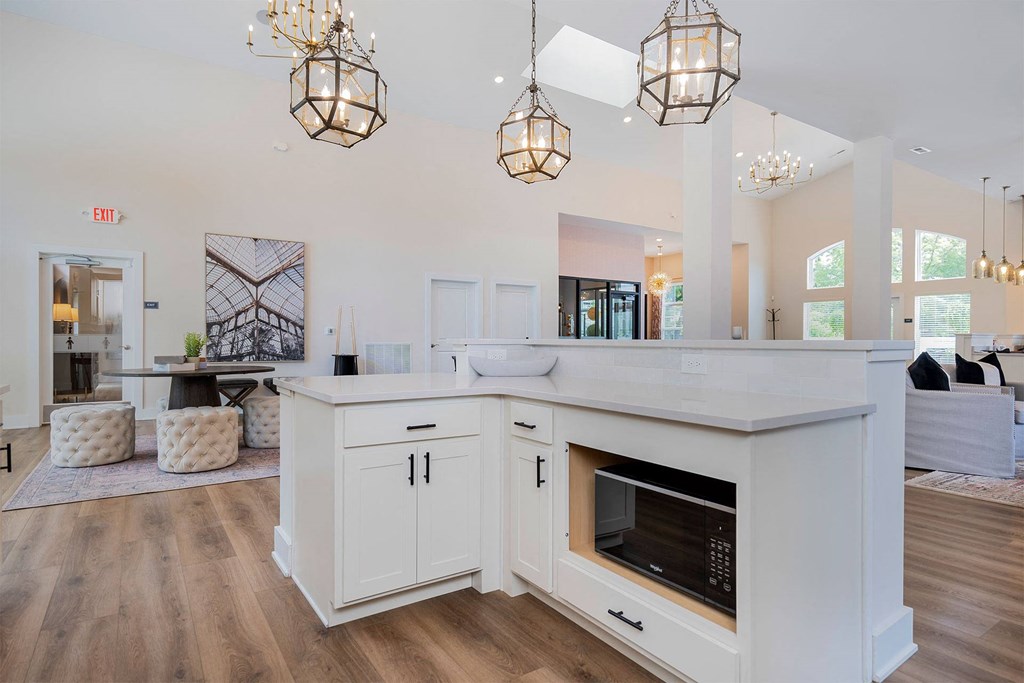 a white kitchen with a fireplace and a counter top