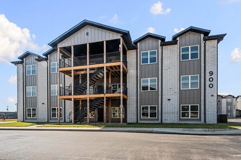 A modern building with a large balcony and staircase.