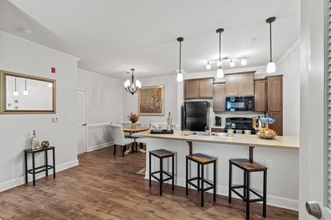 A kitchen with a bar area and a dining table.