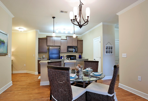 A dining room with a glass table and chairs.