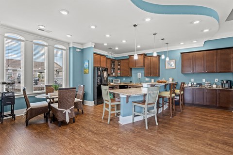 A kitchen with a dining table and chairs.