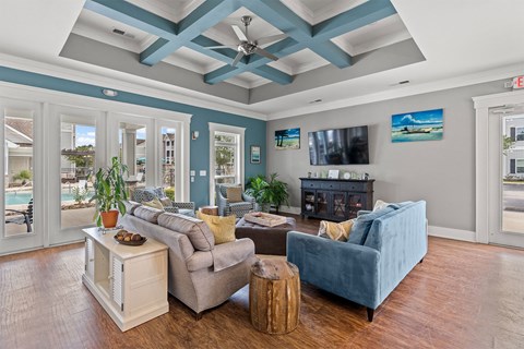 A living room with a blue couch and a white coffee table.