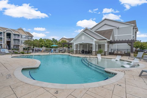 A large outdoor swimming pool with a no step entry.