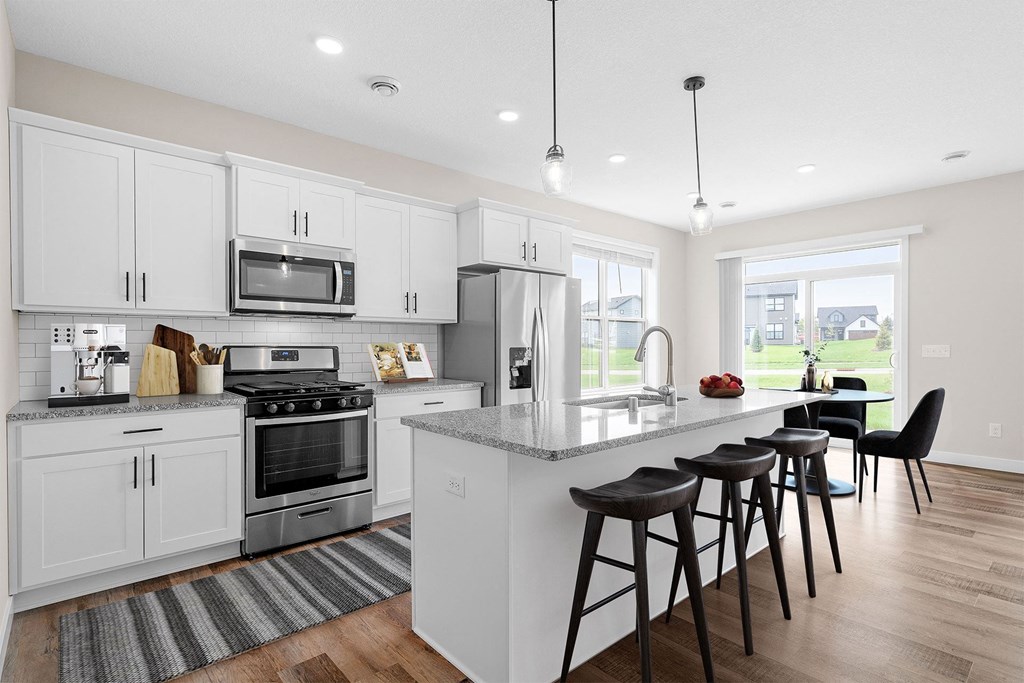 an open kitchen with a large island with bar stools