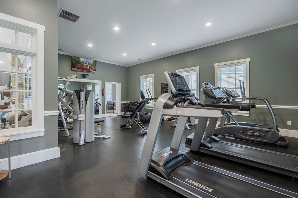 a gym with treadmills and other exercise equipment