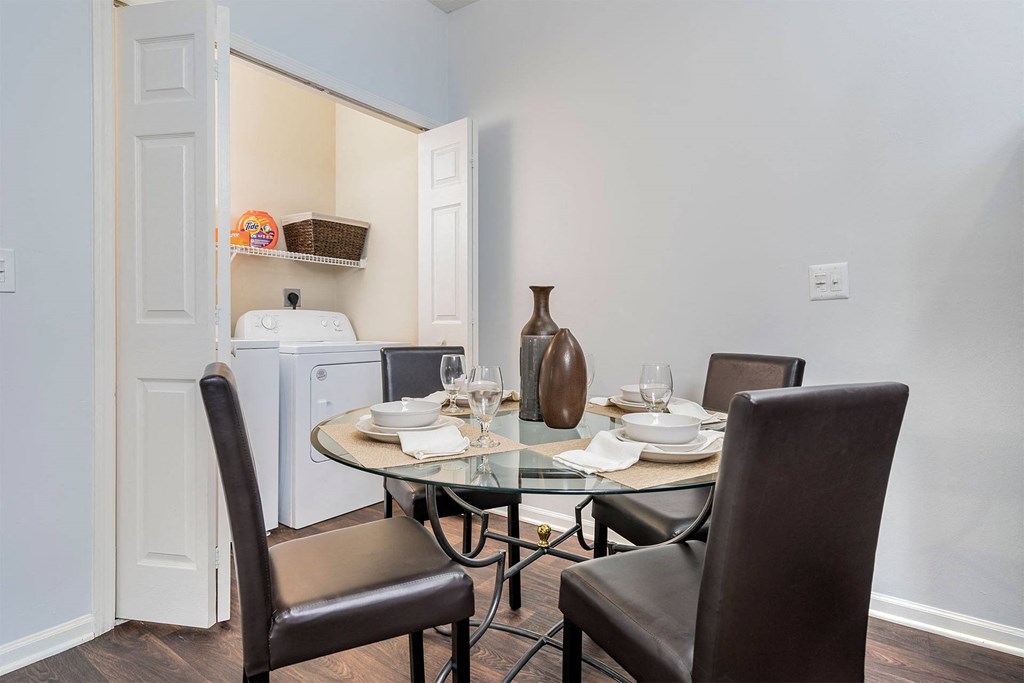 a dining room with a table and chairs and a refrigerator