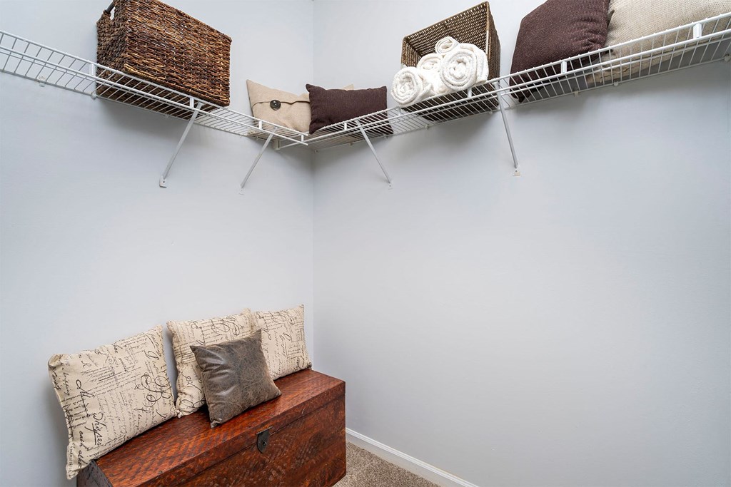 a living room with a couch and a shelf with pillows