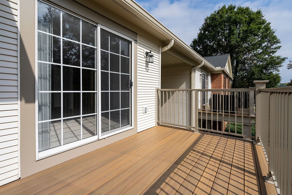 a covered porch with a sliding glass door