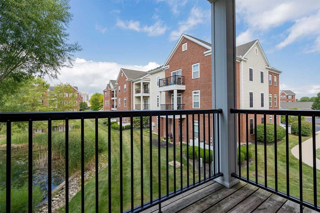 a balcony with a view of an apartment building