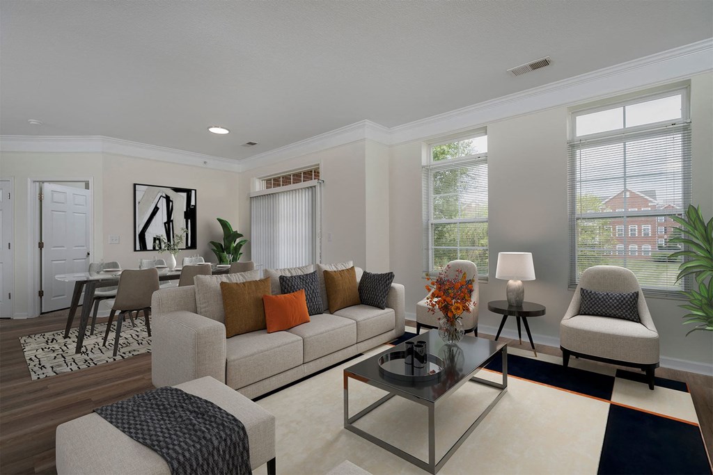 a living room with a couch and chairs and a table