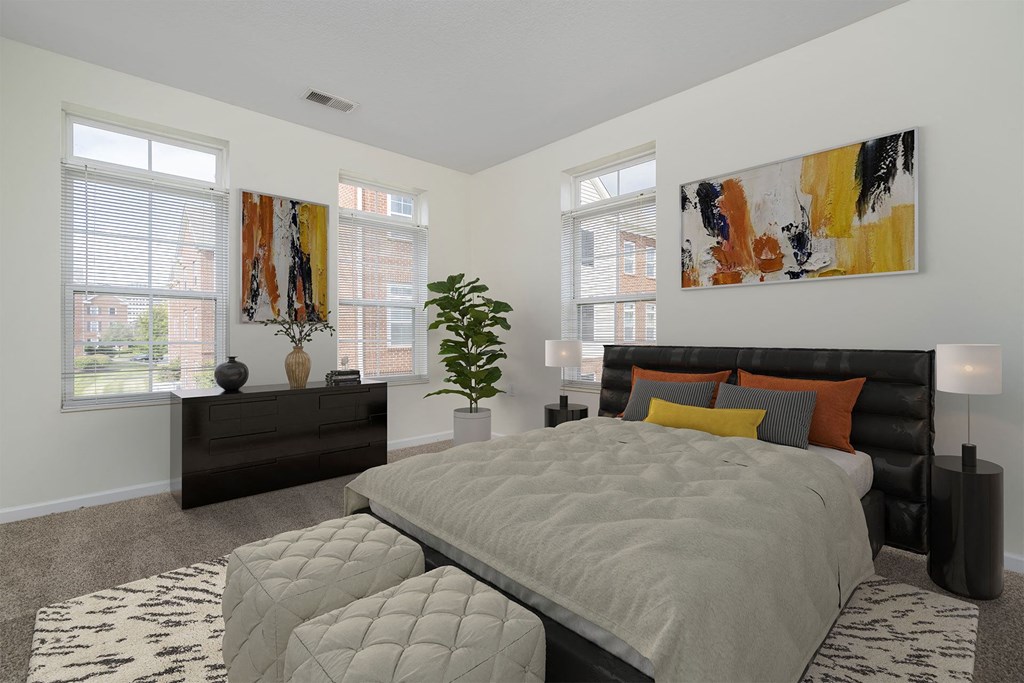 a bedroom with a bed and two windows