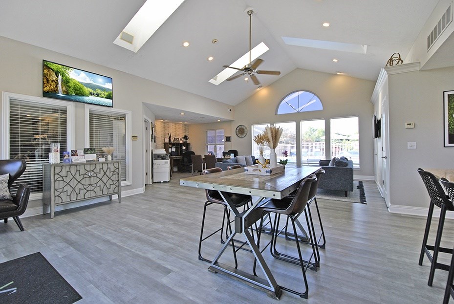 A modern dining room with a large table and chairs.